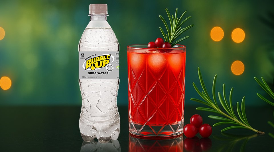 Bubble Up soda water bottle with red cocktail and berries